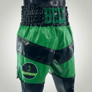 Custom boxing trunks in black and green leatherette with sponsor logo and waistband