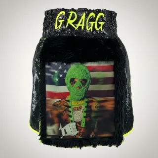 Custom gladiator boxing shorts side view in black long fur with neon satin trim and Warrior design
