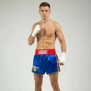 Custom Muay Thai shorts in blue glossy satin with red and yellow details and name waistband