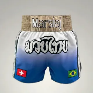 Custom Muay Thai shorts in blue to white gradient satin with gold waistband, flags and appliqué text