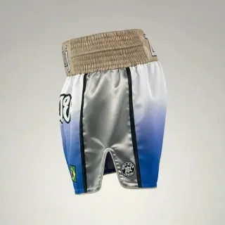 Custom Muay Thai shorts in blue to white gradient satin with gold waistband, flags and appliqué text