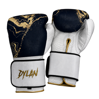 Black and gold marble custom boxing gloves with white snake-textured leather, gold name detail, Arsenal logo, and Velcro wrist design.