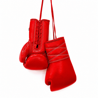 Red leather Impact Pro X lace-up boxing gloves with cross-stitched wrist and white tassels
